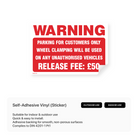 Sign warning of wheel clamping for unauthorized vehicles with a £50 release fee.