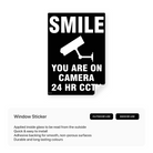 Portrait window sticker with a smiley face and text "You're on camera 24hr CCTV."